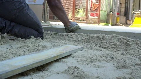 Worker level the sand for paving slabs Stock Footage 89165694