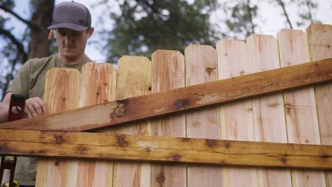 Worker Leveling Cedar Fence Board During Construction Stock Footage 315928285
