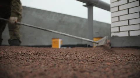 Worker Leveling Expanded Clay on Flat Roof Surface Stock Footage 303784221