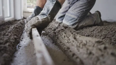 Worker leveling fresh concrete for construction flooring, top view Stock Footage 303181570