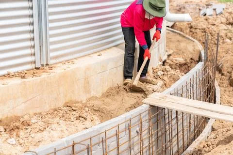 Worker is leveling the ground with a shovel. Stock Photos