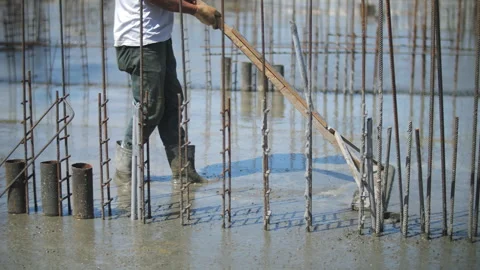 Worker leveling poured concrete at the construction site Stock Footage 276668564