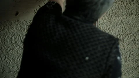 Worker leveling wall plaster with a trowel Stock Footage 300336867