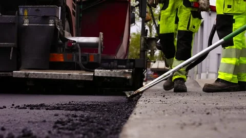 Worker Levels Asphalt Freshly Spread on Gravel with an Asphalt Screed. Stock Footage 303218356