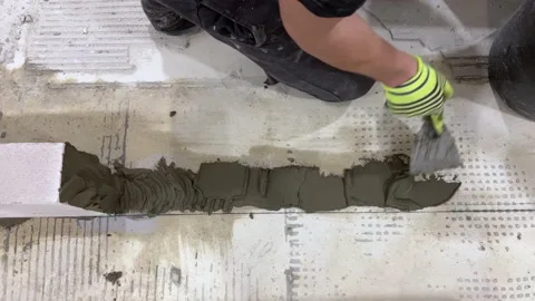 Worker levels cement with a spatula for the construction of a foam block wall. Stock-Footage 167265992