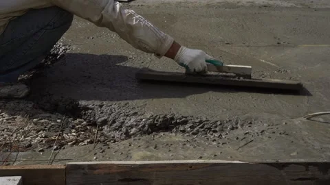 A worker levels the poured concrete mixture Stock Footage 307384271