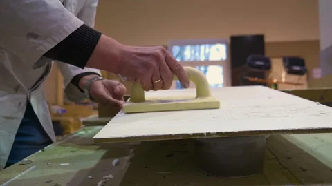 The worker levels the surface with a construction trowel Vídeos de archivo 156512300