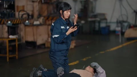 Worker lies motionless on concrete floor 스톡 동영상 340271133