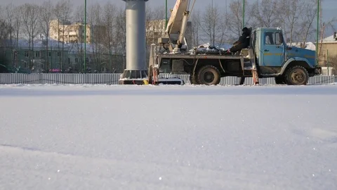 Worker in lift bucket during installation big billboard in bad weather. Workers Stock Footage 84743129