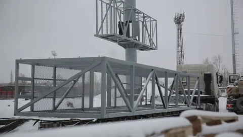 Worker in lift bucket during installation big billboard in bad weather. Workers Stock Footage 84743652