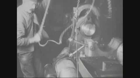 Worker lifting and fitting forged metal in machine Stock Footage 43313338