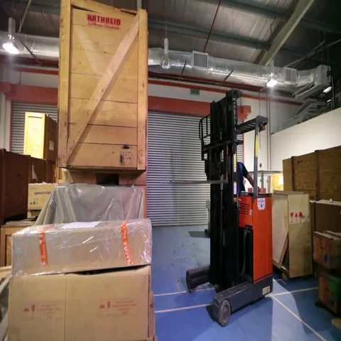 Worker lifting heavy box with the help of a machine Stock-Footage 69615023