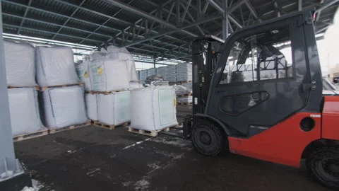 Worker lifts and moves building materials by forklift Stock Footage 228780779
