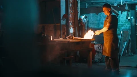 A worker lights an oxy-fuel welding torch, creating a giant flame in a workshop Stock Footage 225462639
