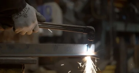 Worker lights a welding torch creating a giant flame Stock Footage 120620005