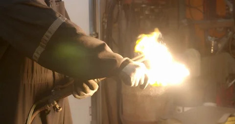 Worker lights a welding torch creating a giant flame Stock Footage 120645053