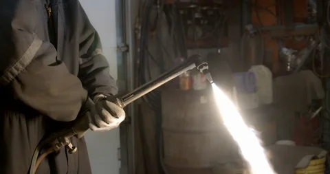 Worker lights a welding torch creating a giant flame Stock Footage 120645489