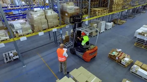Worker loader loading goods boxes warehouse storage HD video. Forklift unload Stock Footage 72219373