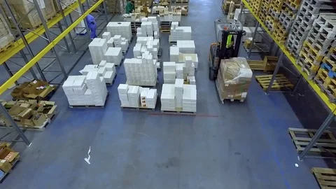 Worker loader transporting boxes warehouse storage HD video. Forklift rides Stock Footage 72219332