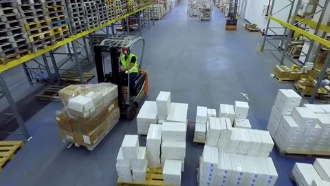 Worker loader transports goods boxes warehouse storage HD video. Forklift rides Stock Footage 72219381