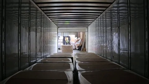 Worker on the loader unload semi-trailer. Shooting from inside of the trailer Stock-Footage 82709287