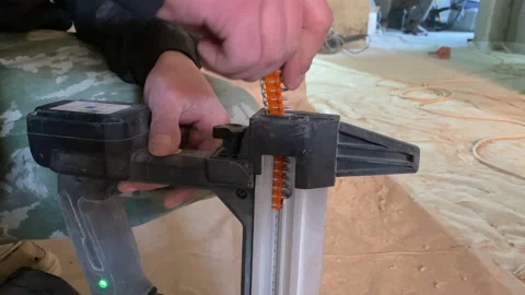 Worker loading gun nailer closeup construction site electrician Stock Footage 150175530