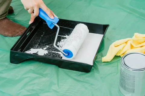 Worker Loading Paint Roller In Tray Before Wall Painting Stock Photos