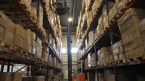 A Worker Loads Products at a High altitude in a Warehouse. A forklift truck. Stock Footage 197334817
