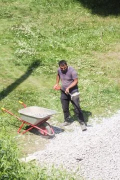 Worker loads rubble. Stock Photos