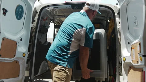 Worker Loads Van with Storm Damage Restoration Supplies and Tools Stock Footage 288534444
