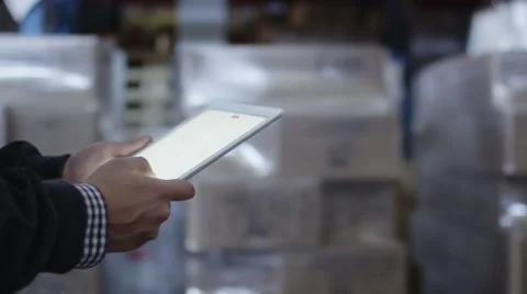 Worker of Logistic Warehouse is Holding Tablet PC in Hands Stock Footage