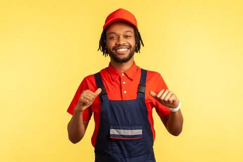 Worker looking at camera with proud expression, pointing at himself, satisfied Foto stock