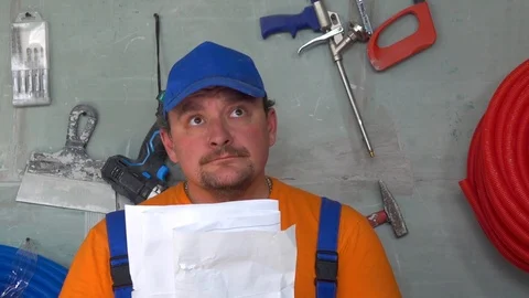 The worker is looking at the drawing, after the inspection is very unhappy Stock Footage 115439247