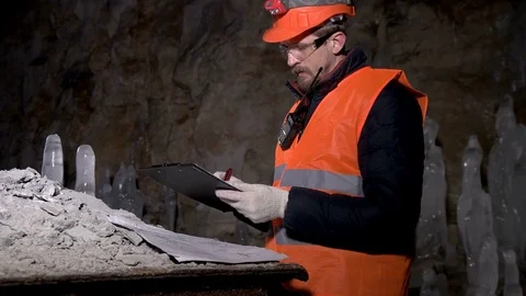 Worker looking drawings in the cave Stock Footage 73177733