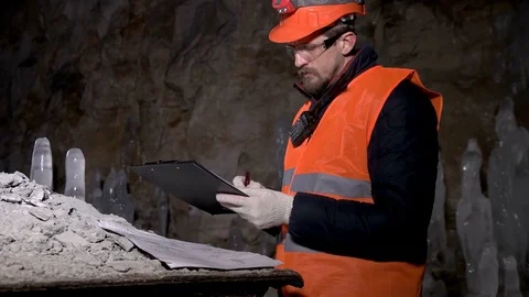 Worker looking drawings in the cave Stock Footage 73183223