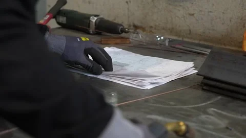 Worker looking at schematics blueprint Stock Footage 256087487