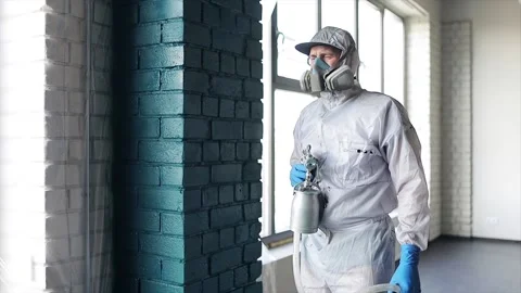 The worker looks at the camera. Professional painter. Portrait of a man Stock Footage 166229343