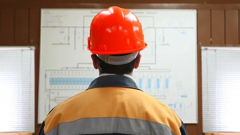 Worker looks at large scheme, closeup Stock Footage 88352818