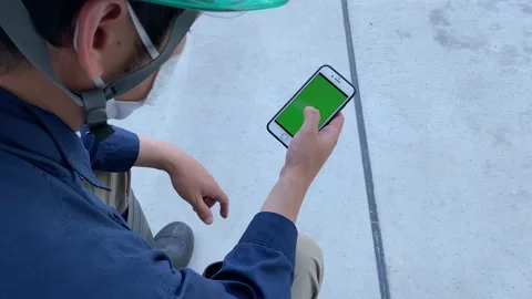 A worker looks at the mobile phone. Stock Footage 131424671