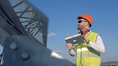 Worker looks at solar panels. Stock Footage 89664213