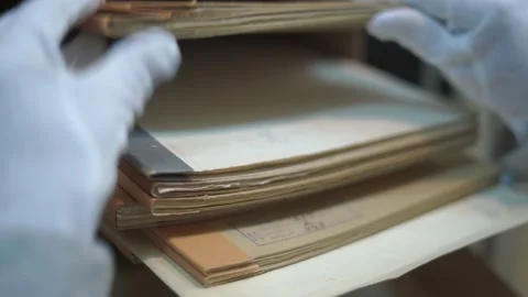 Worker looks through case records lying in box on shelf Stock Footage 164040122