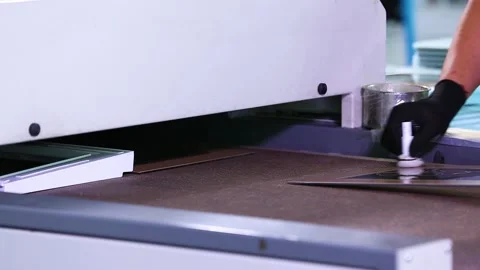 A worker lubricates and stacks plastic and glass parts on a conveyor belt Stock Footage 162902082