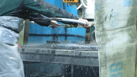 The worker at the machine grinds porcelain stoneware slabs to make porcelain 스톡 동영상 254061871