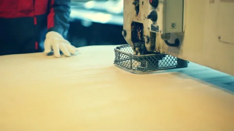 Worker on the machine performs work on marking individual sheets of plywood Stock Footage 92200022