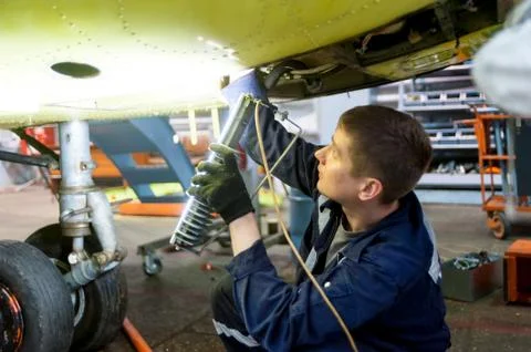 Worker maintaining a Mi-8 helicopter. Tyumen Stock Photos