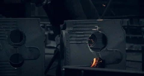 The worker makes adjustments to the metal part. Sparks that fly out when Stock Footage 123898498
