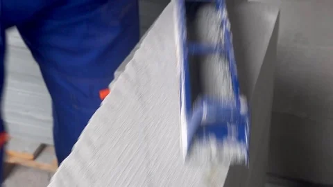 Worker makes apartment renovation, align the edge of the tile with a planer Stock Footage 114894636