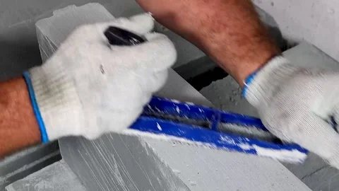 Worker makes apartment renovation, align the edge of the tile with a planer Stock Footage 114895346