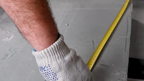 A worker makes an apartment repair, measures with a tape measure Stock Footage 114895195