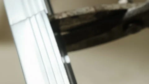 Worker makes cuts on metal plank using sharp cutters Stock-Footage 304406107